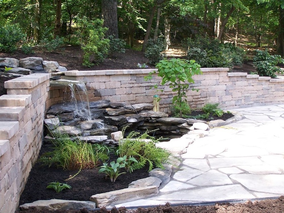 Photo of a large shade side yard concrete paver garden path.