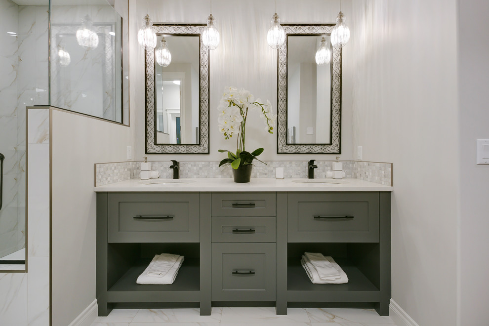 This is an example of a large transitional master bathroom in Calgary with shaker cabinets, an alcove shower, white tile, grey walls, an undermount sink, quartzite benchtops, white floor, a hinged shower door, white benchtops and green cabinets.