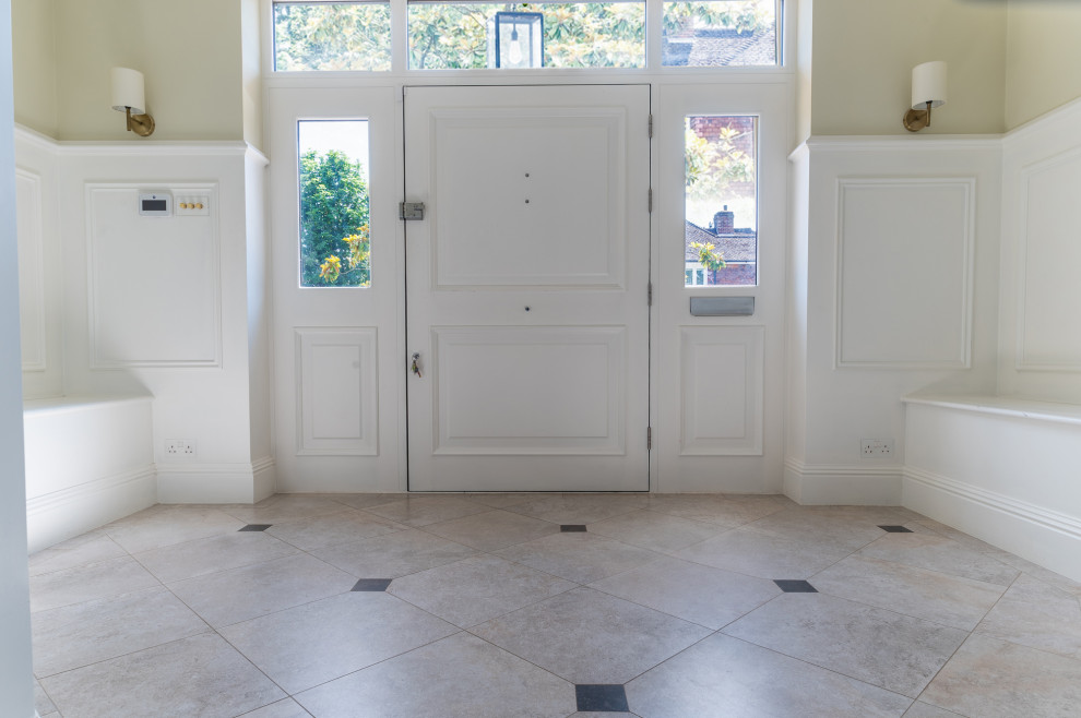 Design ideas for an expansive arts and crafts entryway in Surrey with beige walls, porcelain floors and white floor.