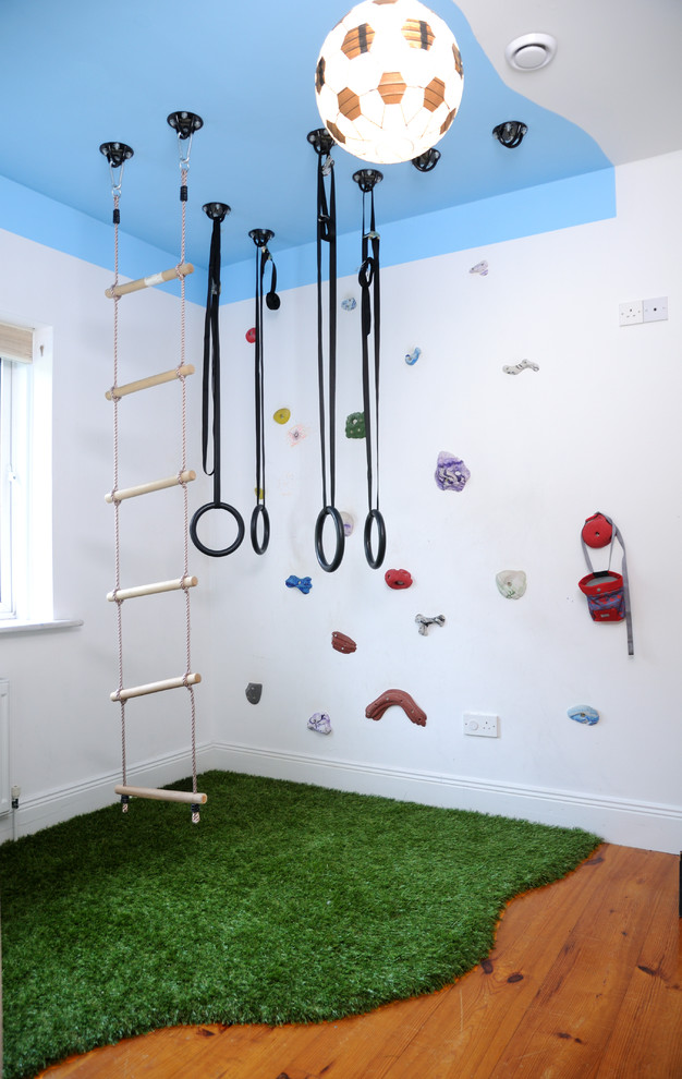 Photo of a mid-sized contemporary gender-neutral kids' playroom in Other with multi-coloured walls.