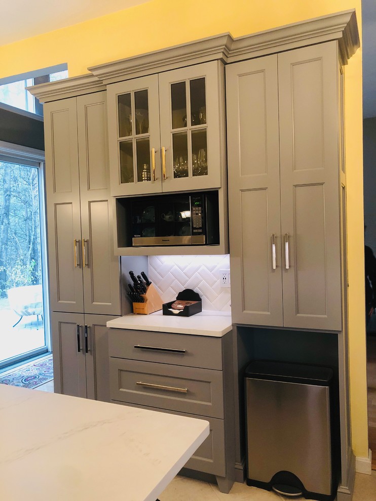 Photo of a small modern u-shaped kitchen pantry in Boston with a single-bowl sink, shaker cabinets, grey cabinets, marble benchtops, white splashback, subway tile splashback, stainless steel appliances, ceramic floors, a peninsula, beige floor and white benchtop.