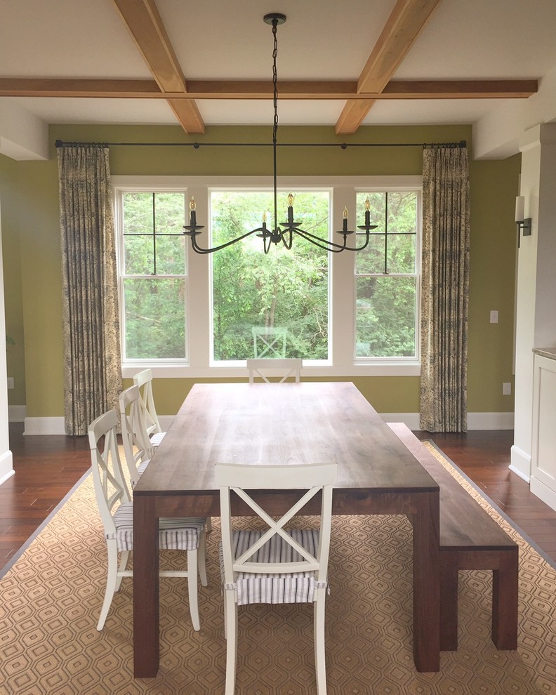 This is an example of an expansive country kitchen/dining combo in Columbus with green walls, medium hardwood floors, no fireplace and brown floor.