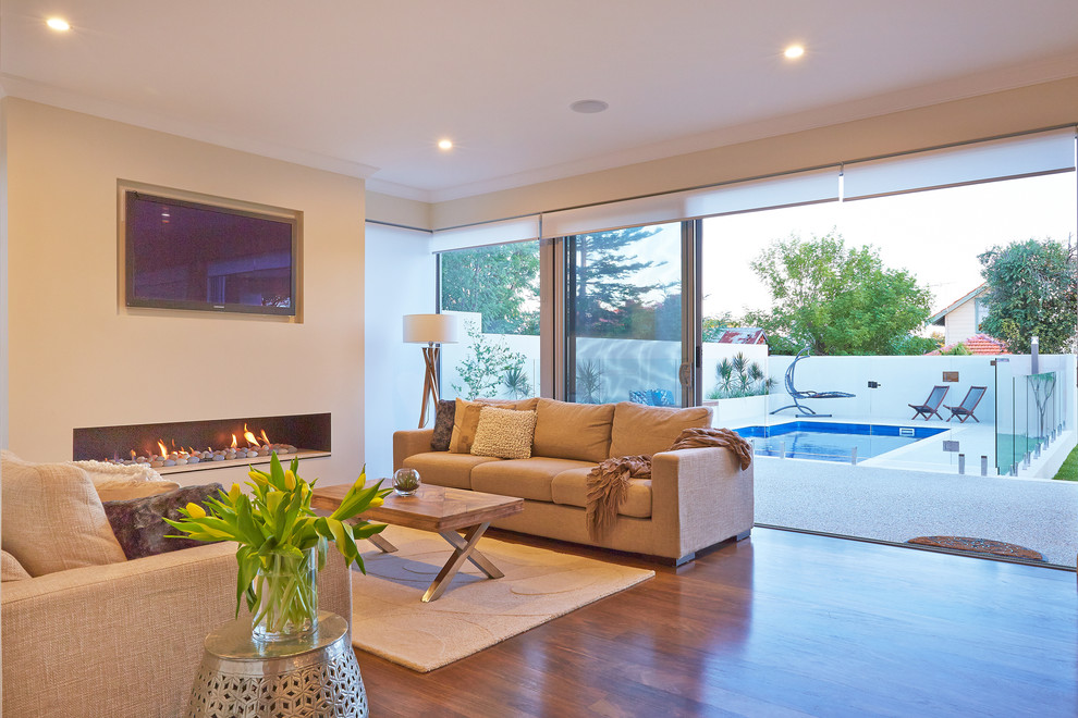 Design ideas for a contemporary living room in Perth with medium hardwood floors and a ribbon fireplace.
