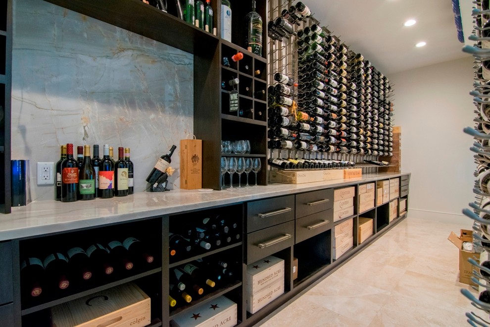 Inspiration for a large contemporary wine cellar in Orange County with marble floors, storage racks and beige floor.