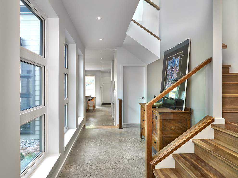 Photo of a mid-sized contemporary hallway in Edmonton with grey floor, grey walls and concrete floors.