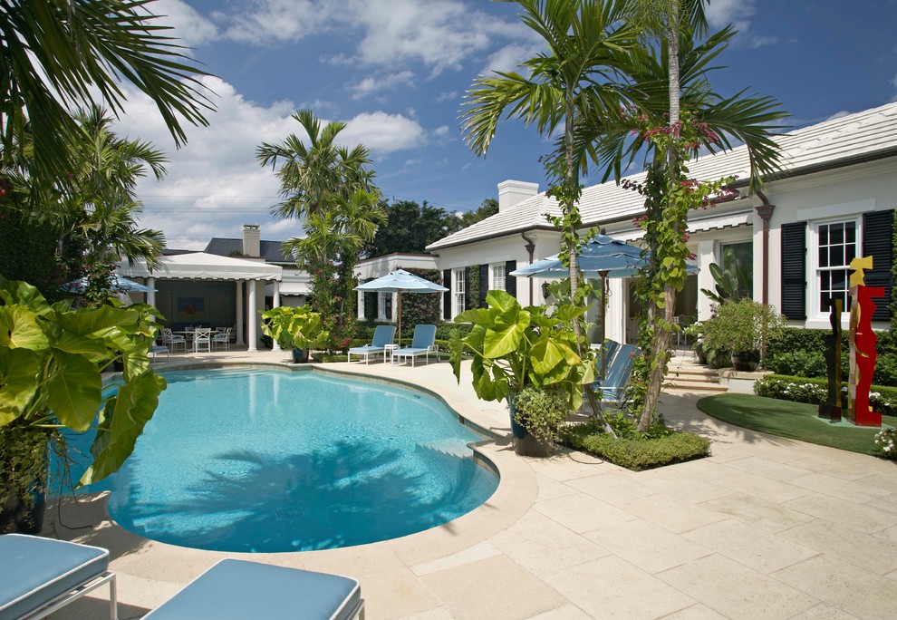 Inspiration for a beach style backyard round pool in Miami with a pool house.