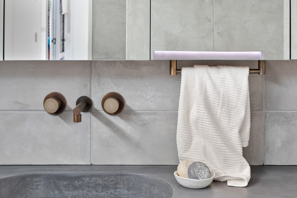 Design ideas for a large industrial master bathroom in Sydney with furniture-like cabinets, medium wood cabinets, an open shower, a wall-mount toilet, gray tile, porcelain tile, grey walls, porcelain floors, an integrated sink, concrete benchtops, grey floor, an open shower, grey benchtops, a niche, a single vanity and a floating vanity.