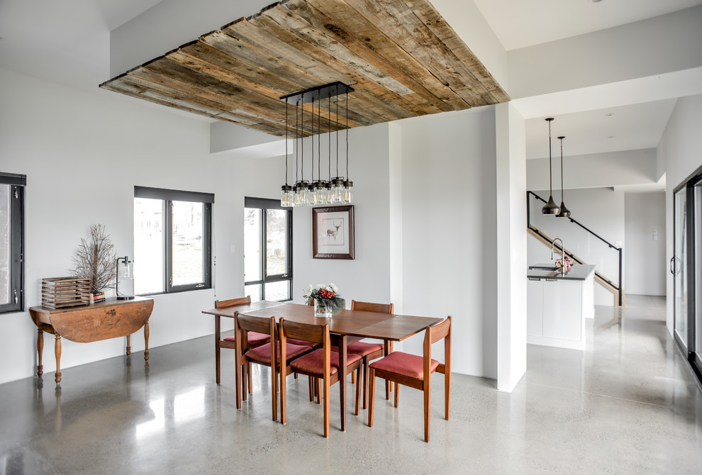 Inspiration for a large contemporary concrete floor and gray floor great room remodel in Toronto with white walls and no fireplace