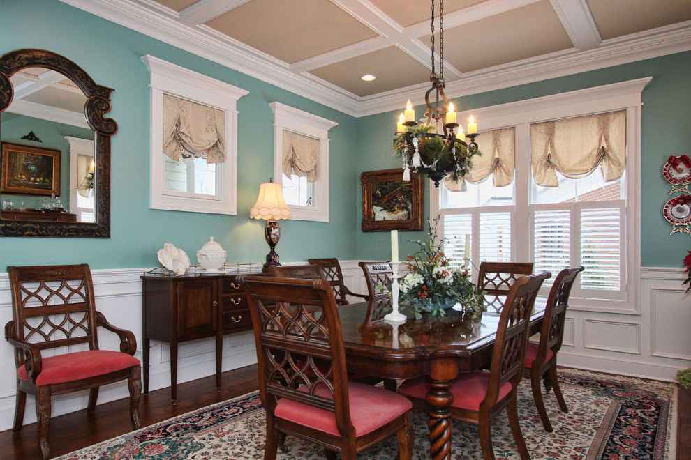 Design ideas for a traditional separate dining room in Louisville with blue walls, dark hardwood floors, brown floor, coffered and panelled walls.