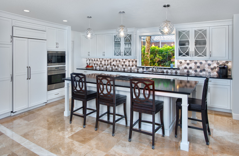 Photo of a large transitional single-wall open plan kitchen in Miami with an undermount sink, recessed-panel cabinets, white cabinets, quartz benchtops, multi-coloured splashback, stainless steel appliances, marble floors, with island, beige floor and brown benchtop.