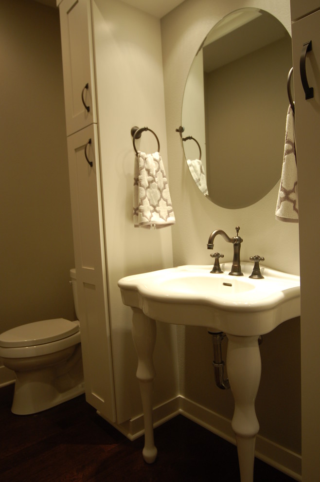 Inspiration for a small transitional dark wood floor bathroom remodel with a pedestal sink, furniture-like cabinets, white cabinets, a two-piece toilet and gray walls