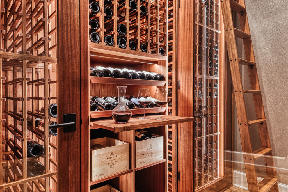 Inspiration for a small arts and crafts wine cellar in Portland with cork floors and storage racks.