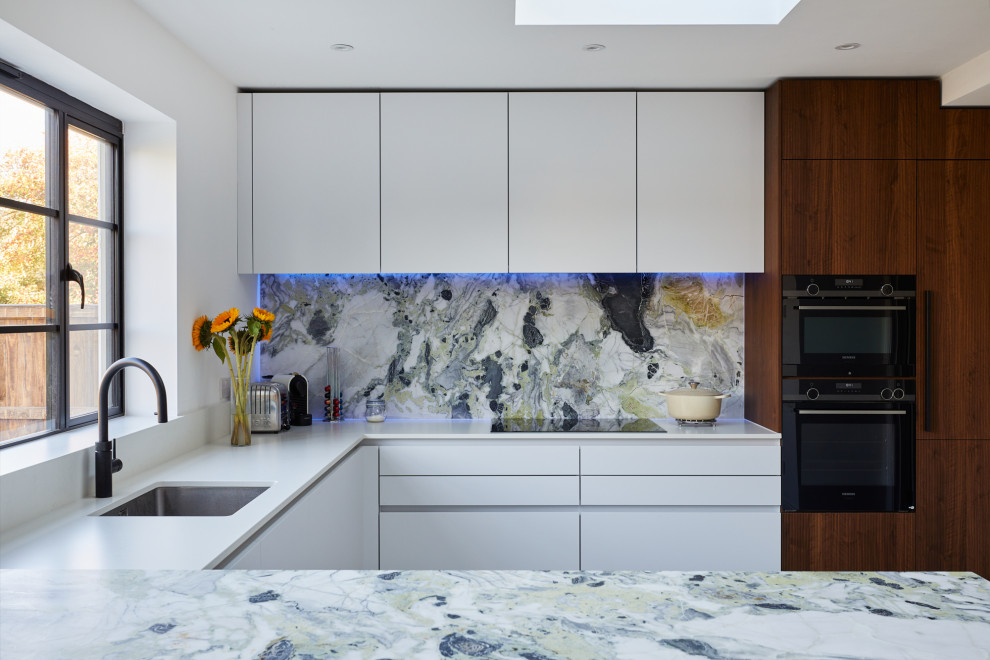 Design ideas for a mid-sized modern u-shaped eat-in kitchen in London with an undermount sink, flat-panel cabinets, marble benchtops, multi-coloured splashback, marble splashback, with island and multi-coloured benchtop.