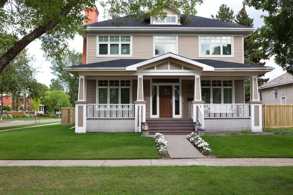 This is an example of a mid-sized arts and crafts two-storey exterior in Edmonton with wood siding.