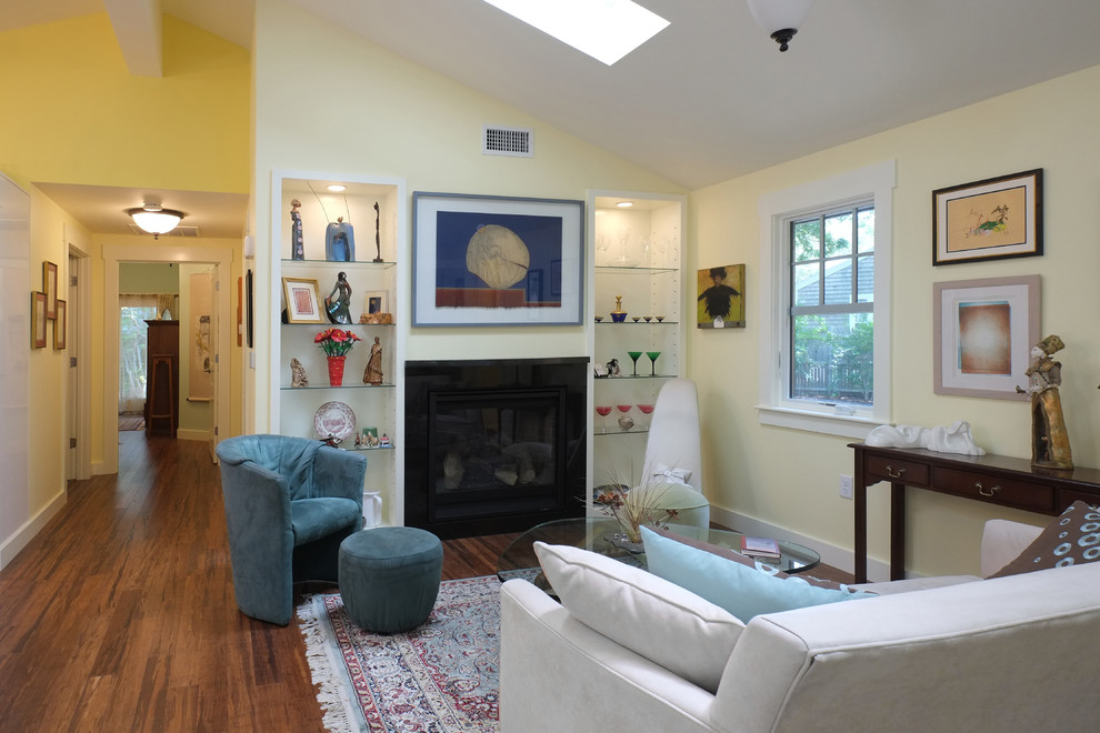 This is an example of a large transitional formal open concept living room in Boston with yellow walls, dark hardwood floors, no fireplace and no tv.