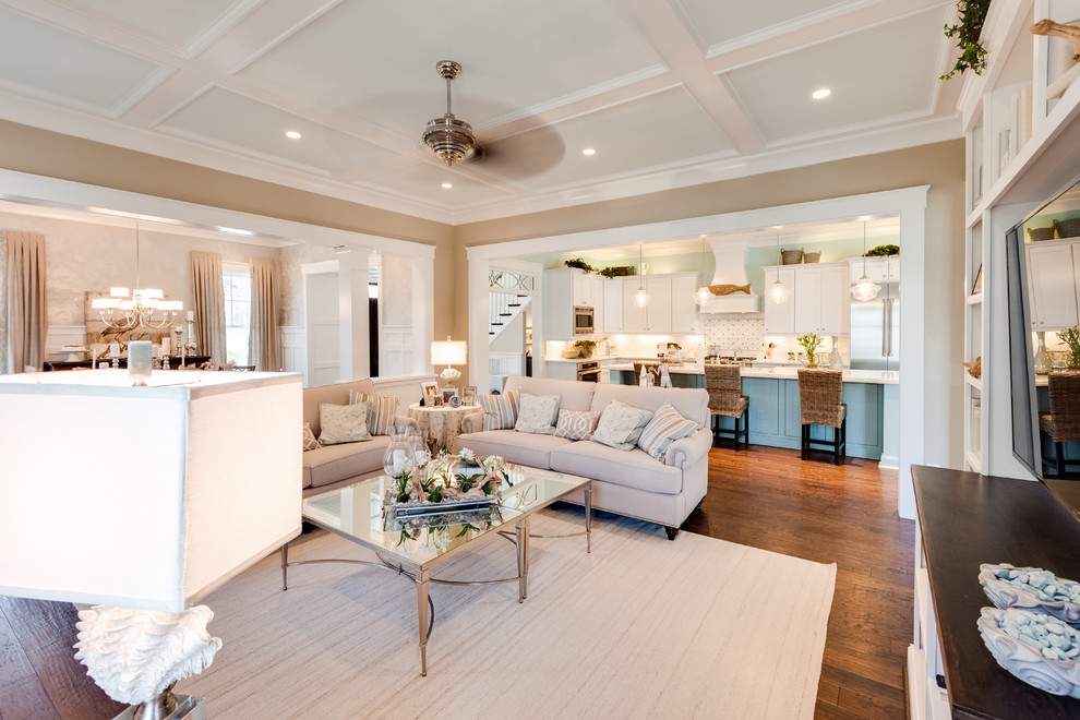 Photo of a large beach style open concept family room in Other with beige walls, medium hardwood floors, a standard fireplace, a stone fireplace surround and a built-in media wall.