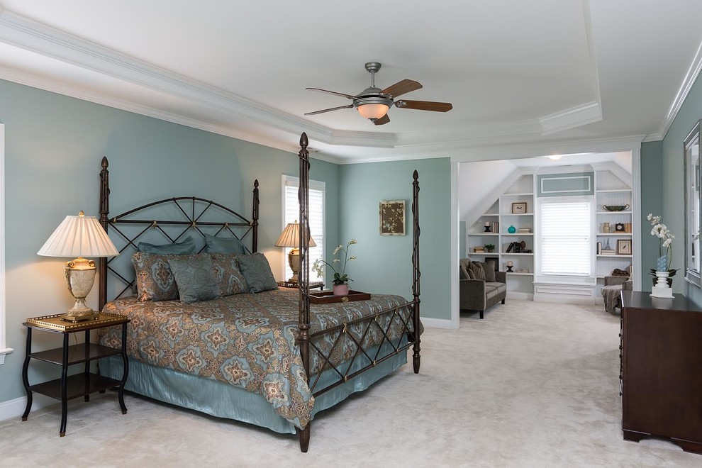 This is an example of a large traditional master bedroom in Raleigh with blue walls, carpet, no fireplace and white floor.