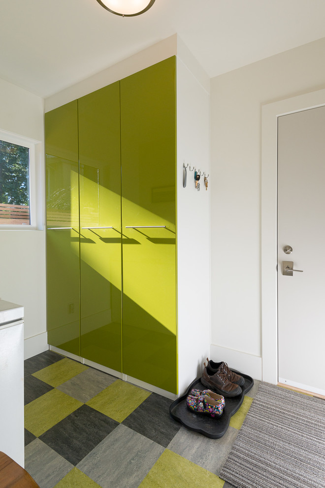 This is an example of a contemporary mudroom in Vancouver with a white front door.