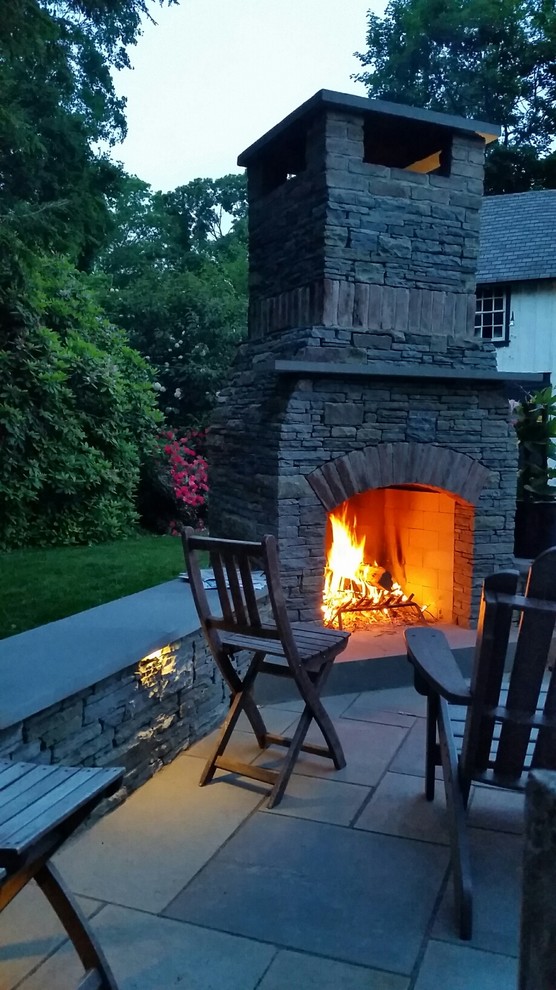 Inspiration for a mid-sized country backyard patio in Philadelphia with a fire feature, natural stone pavers and no cover.