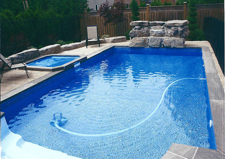 Inspiration for a mid-sized transitional backyard stone and rectangular pool fountain remodel in Toronto