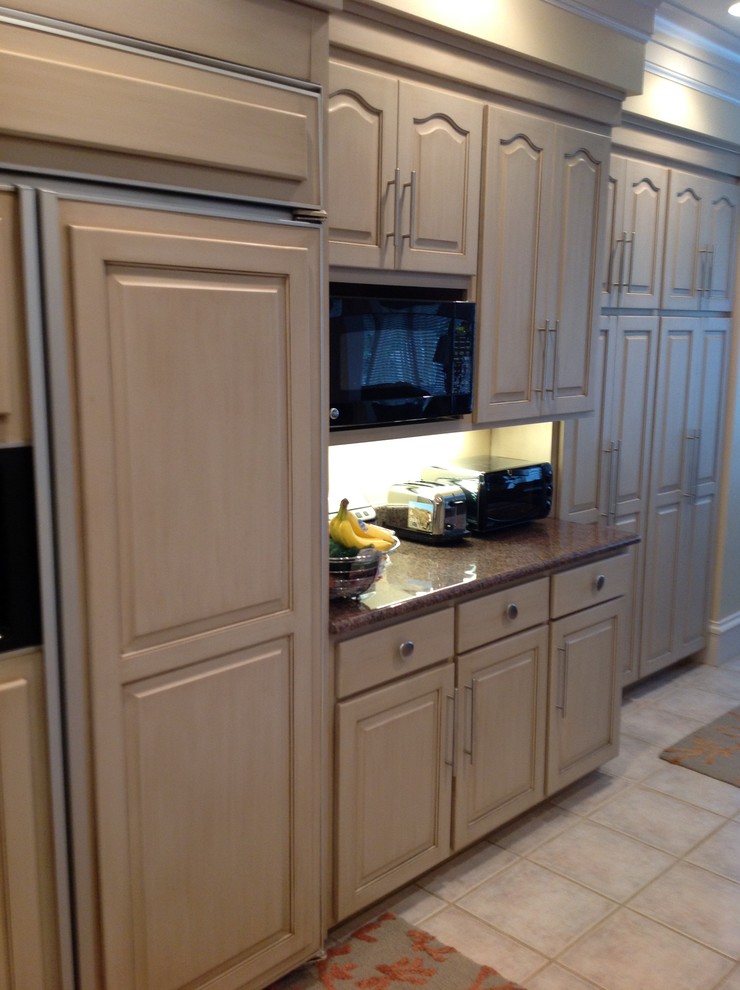 Open concept kitchen - large transitional open concept kitchen idea with raised-panel cabinets, beige cabinets, granite countertops and an island
