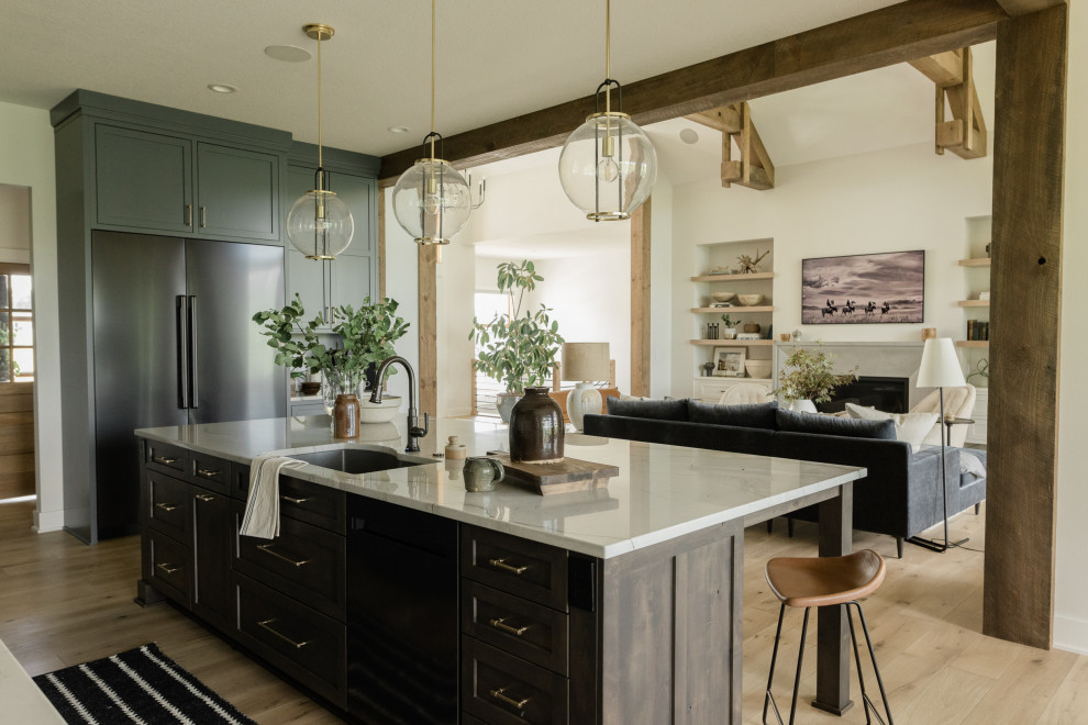 Example of a large transitional l-shaped light wood floor open concept kitchen design in Other with an undermount sink, recessed-panel cabinets, gray cabinets, quartzite countertops, white backsplash, marble backsplash, black appliances, an island and white countertops