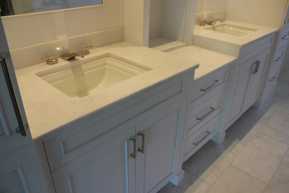 Inspiration for a large transitional master marble floor and white floor doorless shower remodel with shaker cabinets, white cabinets, white walls, an undermount sink, marble countertops and white countertops