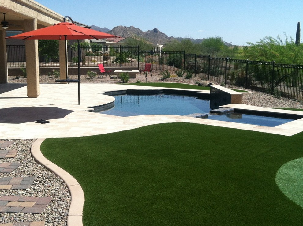 Inspiration for a mid-sized contemporary backyard full sun xeriscape for summer in Phoenix with gravel.