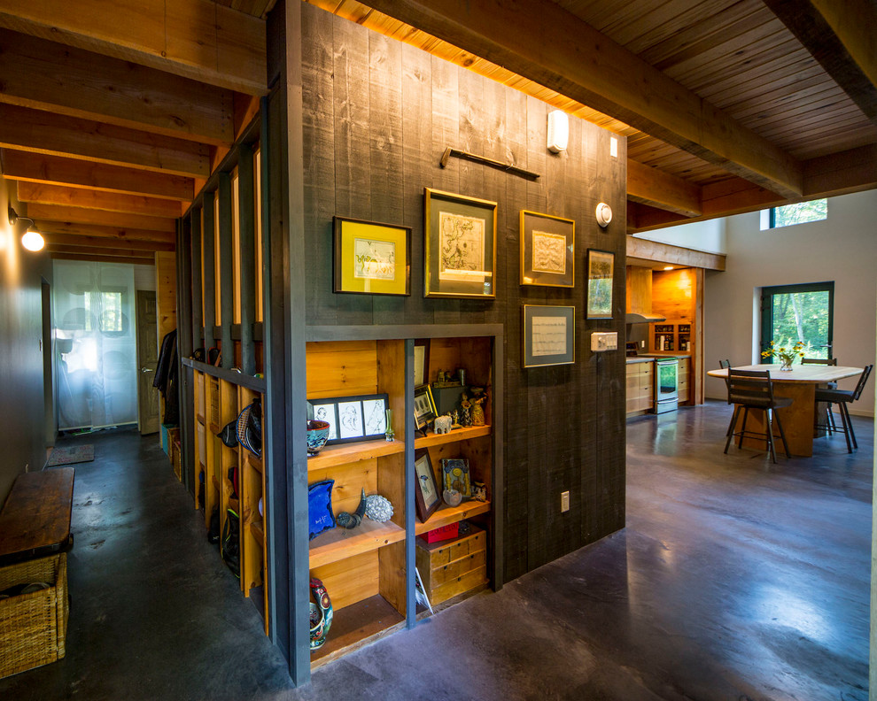 Example of a mid-sized mountain style concrete floor and gray floor foyer design in Ottawa with brown walls and a red front door