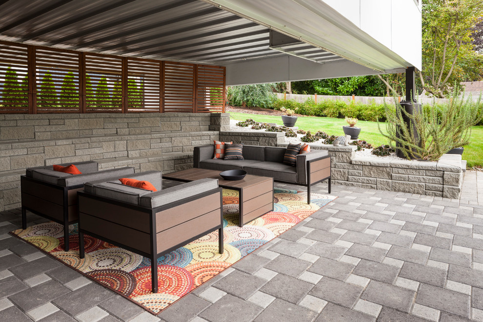 Design ideas for a mid-sized contemporary backyard patio in Seattle with concrete pavers.