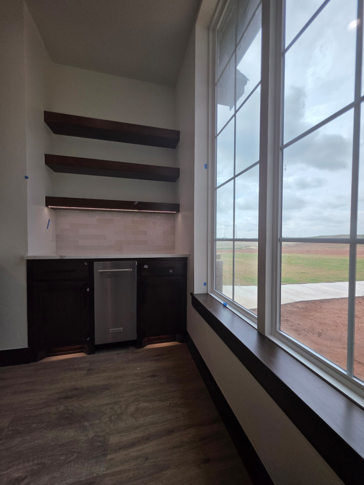 The pantry features an ice maker, under cabinet & floor lightingh