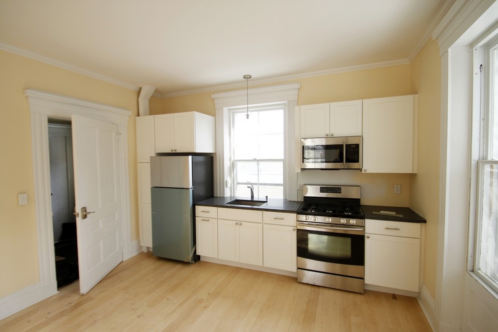 Kitchen - transitional single-wall light wood floor kitchen idea in Burlington with an undermount sink, granite countertops, stainless steel appliances and no island