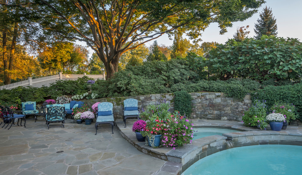Inspiration for a small contemporary backyard pool in DC Metro with natural stone pavers.