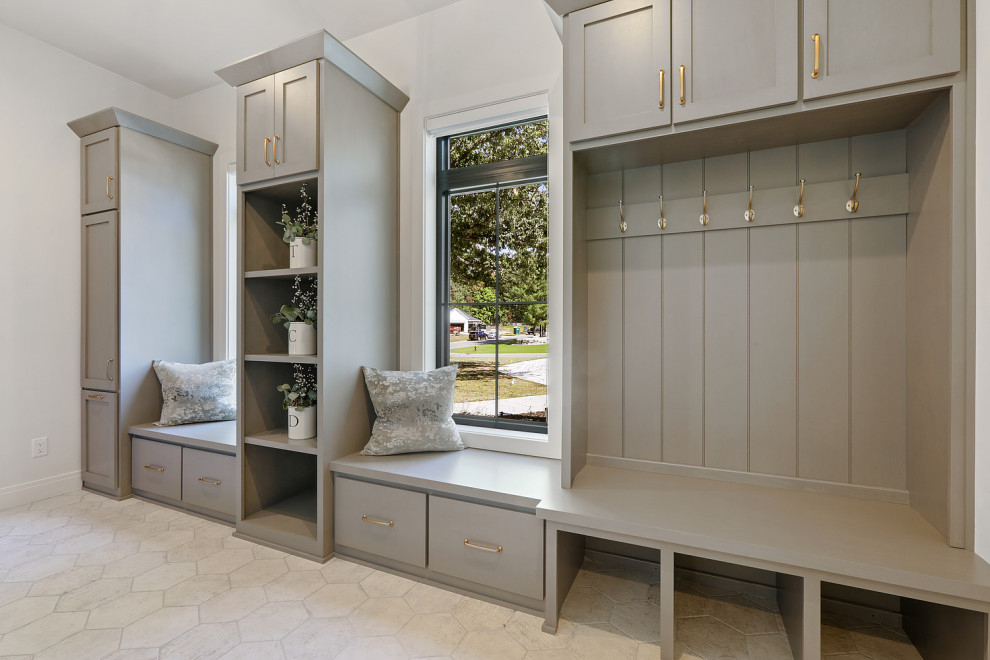 Inspiration for a large transitional porcelain tile and white floor mudroom remodel with white walls