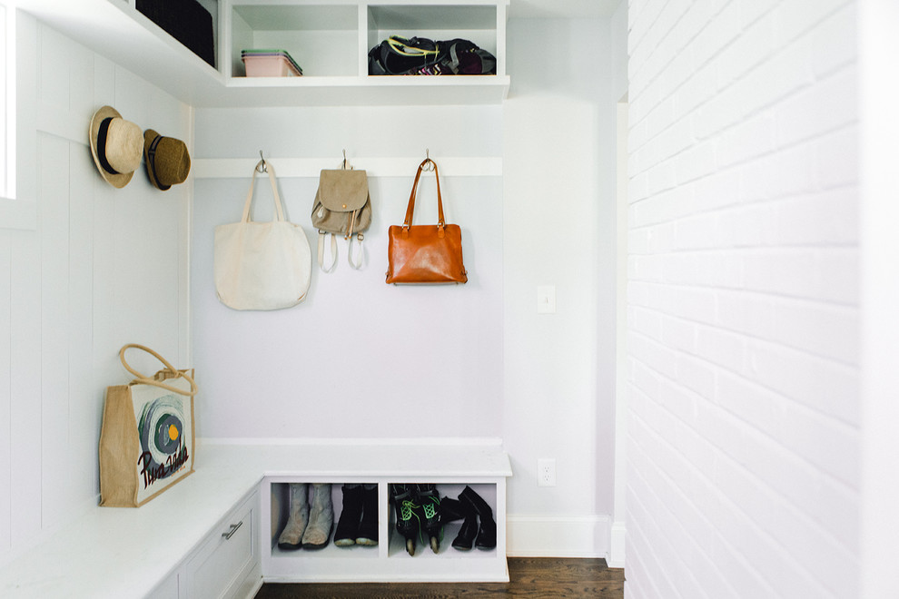 This is an example of a transitional mudroom in Atlanta with white walls and dark hardwood floors.