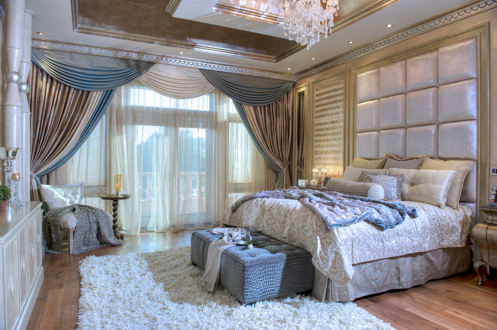 This is an example of a large traditional master bedroom in Miami with multi-coloured walls, medium hardwood floors, no fireplace and brown floor.