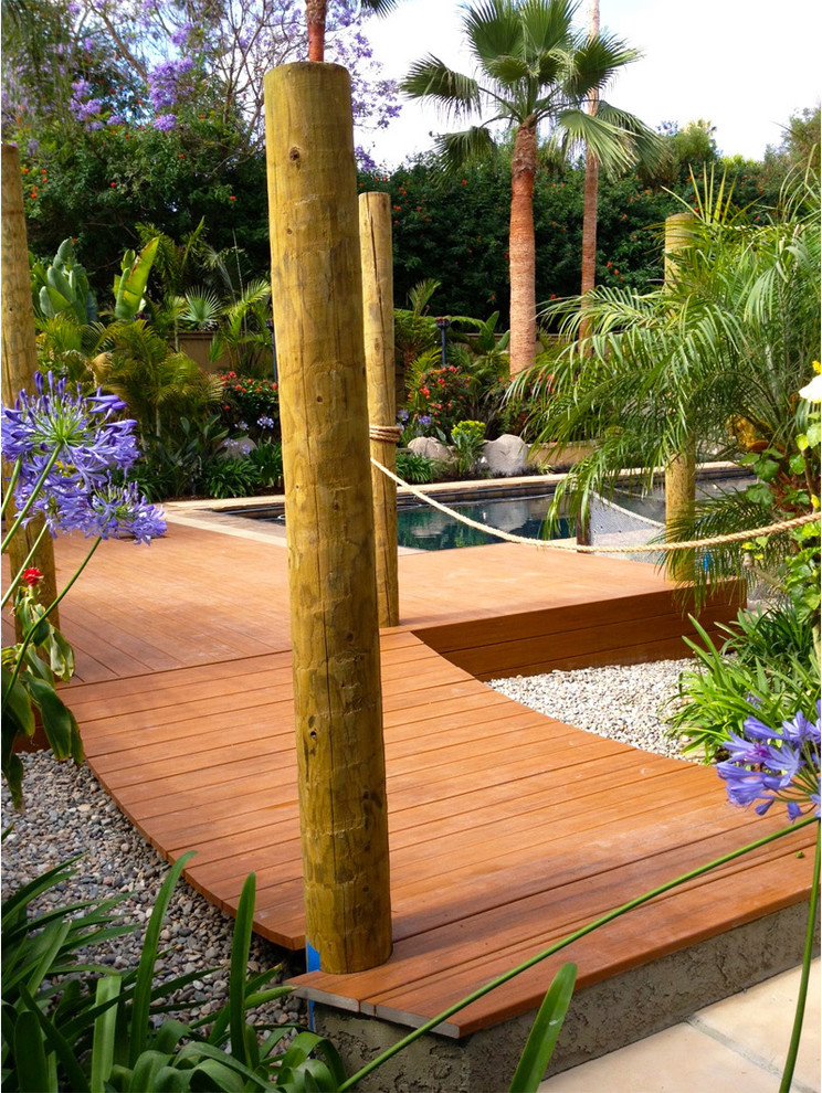 Photo of a large tropical backyard patio in San Diego with decking and no cover.