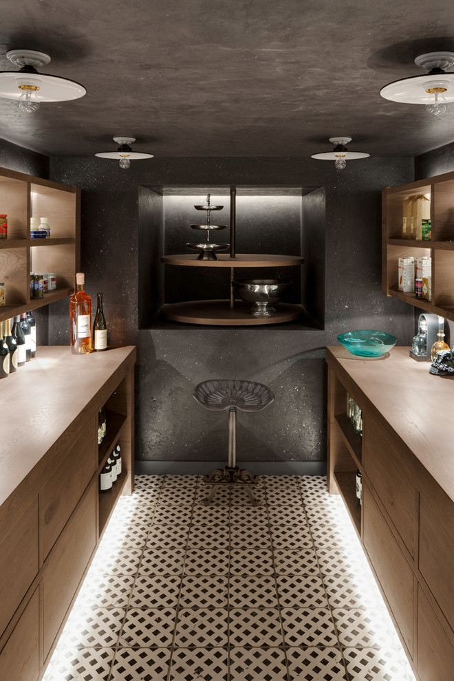 Design ideas for a small contemporary galley seated home bar in Hamburg with flat-panel cabinets, medium wood cabinets, wood benchtops, black splashback, ceramic floors, white floor and brown benchtop.