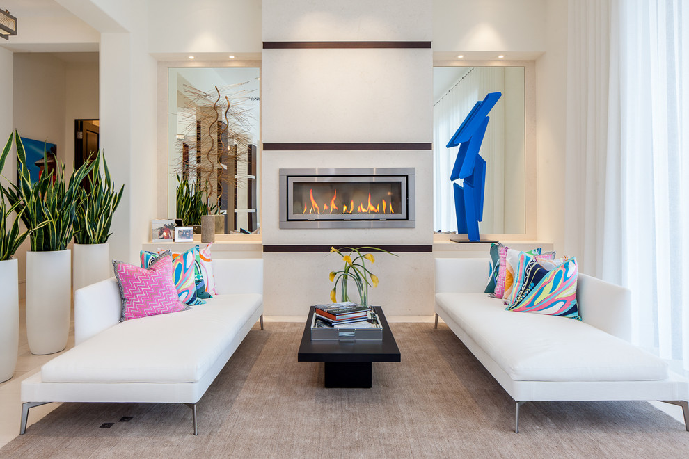 Photo of a contemporary formal living room in Miami with beige walls, a ribbon fireplace and a metal fireplace surround.
