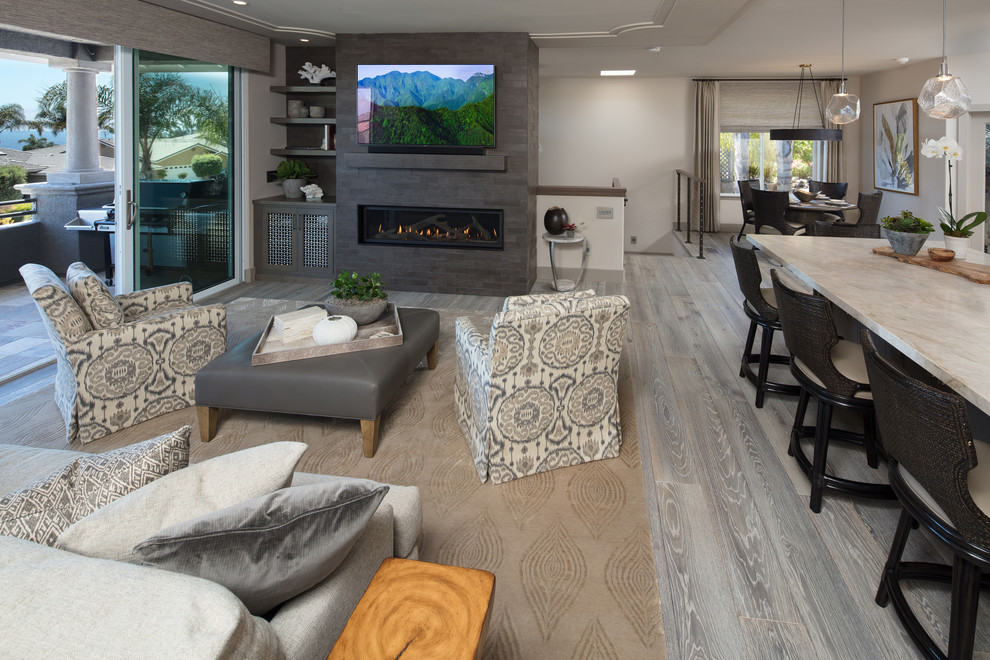 Mid-sized transitional formal open concept living room in San Luis Obispo with white walls, light hardwood floors, a ribbon fireplace, a tile fireplace surround, a wall-mounted tv and grey floor.