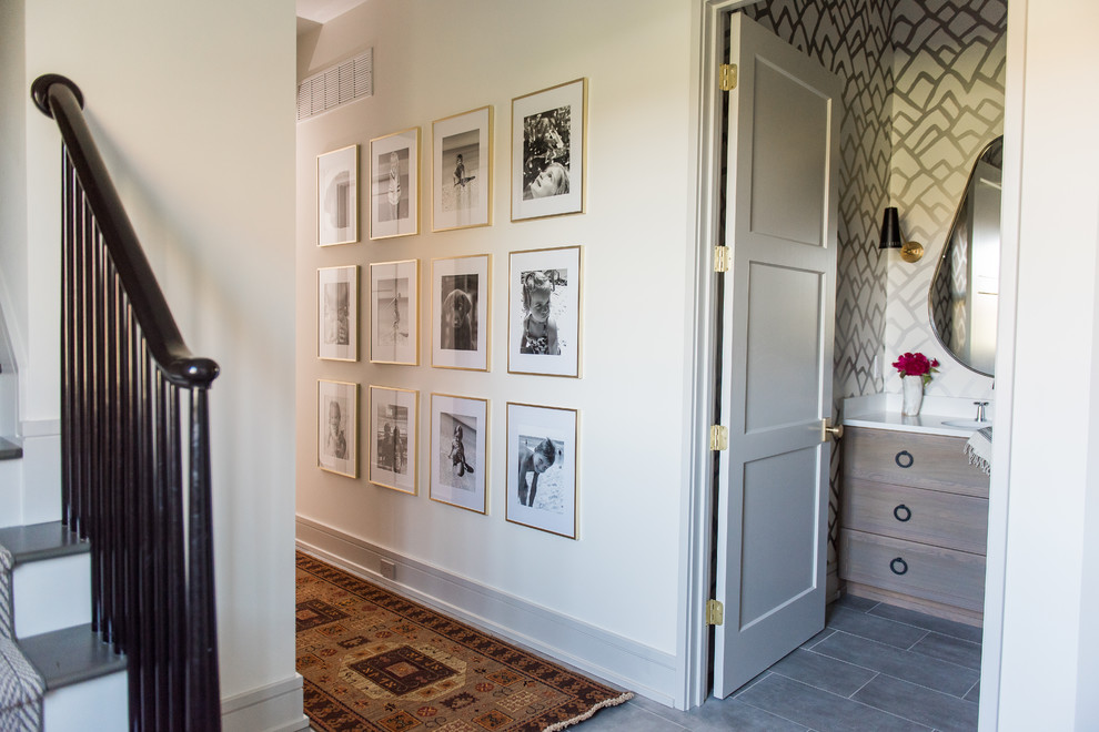 Hallway - mid-sized transitional porcelain tile and gray floor hallway idea in Indianapolis with white walls