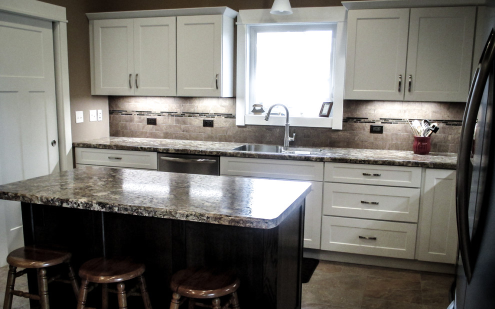 Example of a transitional vinyl floor eat-in kitchen design with white cabinets, beige backsplash, stainless steel appliances and an island