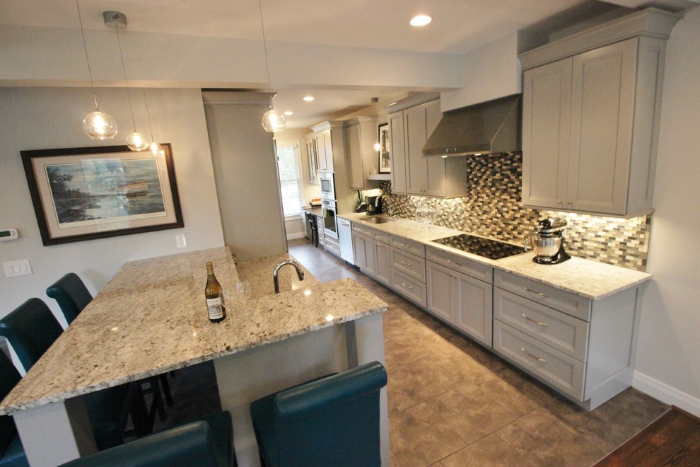 Inspiration for a mid-sized transitional galley dark wood floor eat-in kitchen remodel with a drop-in sink, gray cabinets, granite countertops, multicolored backsplash, stainless steel appliances and an island