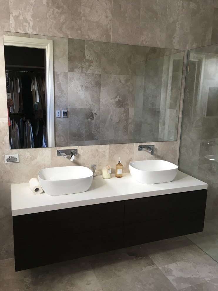 Design ideas for a mid-sized modern 3/4 bathroom in Adelaide with furniture-like cabinets, dark wood cabinets, gray tile, travertine, multi-coloured walls, travertine floors, quartzite benchtops, grey floor, an open shower, a vessel sink, an open shower, white benchtops and a one-piece toilet.