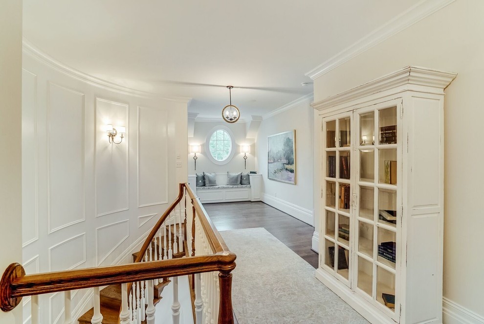 Large transitional hallway in Richmond with white walls and medium hardwood floors.