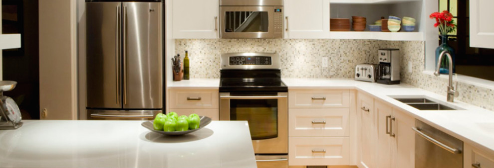 Example of an u-shaped eat-in kitchen design in Ottawa with an integrated sink, raised-panel cabinets, dark wood cabinets, soapstone countertops, white backsplash, mosaic tile backsplash, stainless steel appliances and an island