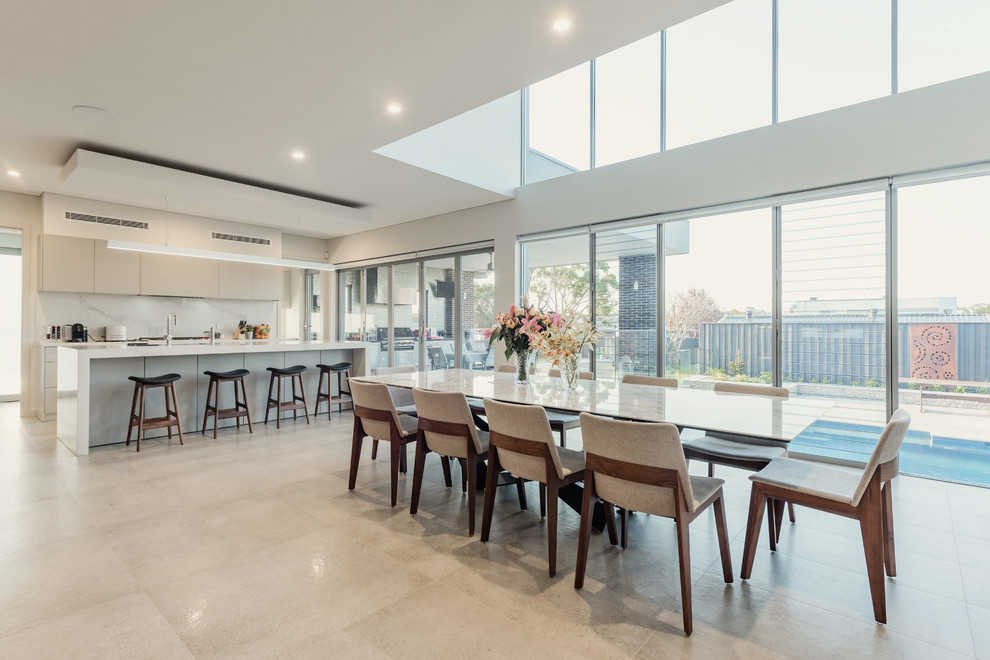 Design ideas for a contemporary open plan dining in Sydney with beige walls and beige floor.