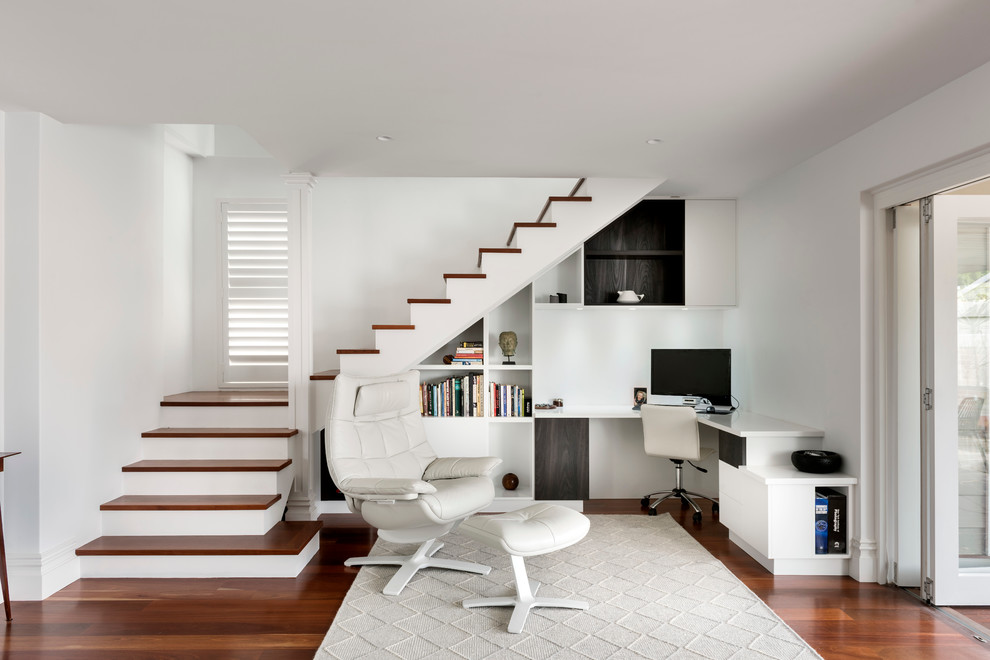 Photo of a transitional study room in Perth with white walls, dark hardwood floors, no fireplace and a built-in desk.