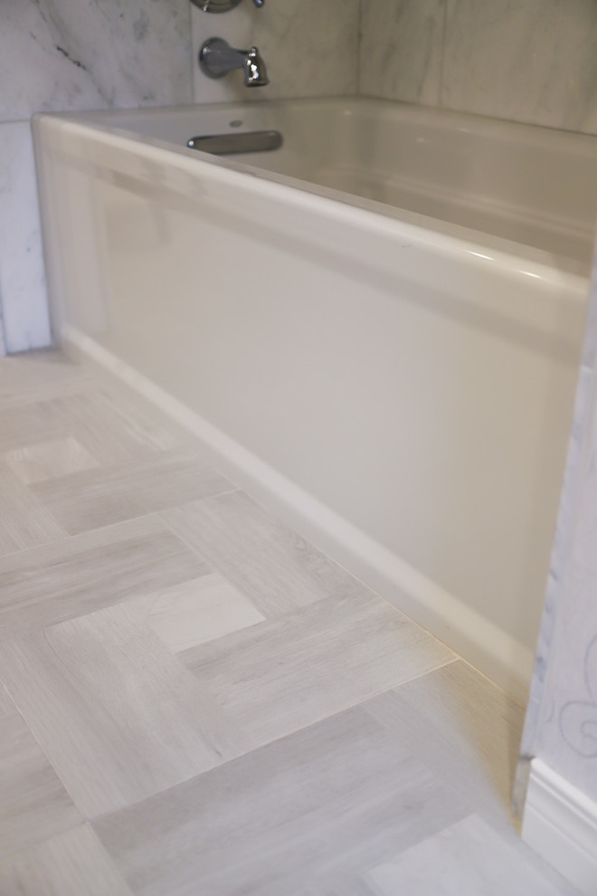Inspiration for a mid-sized transitional master white tile and marble tile ceramic tile and gray floor alcove bathtub remodel with gray walls, beaded inset cabinets, white cabinets, a two-piece toilet, an undermount sink, quartzite countertops and a hinged shower door
