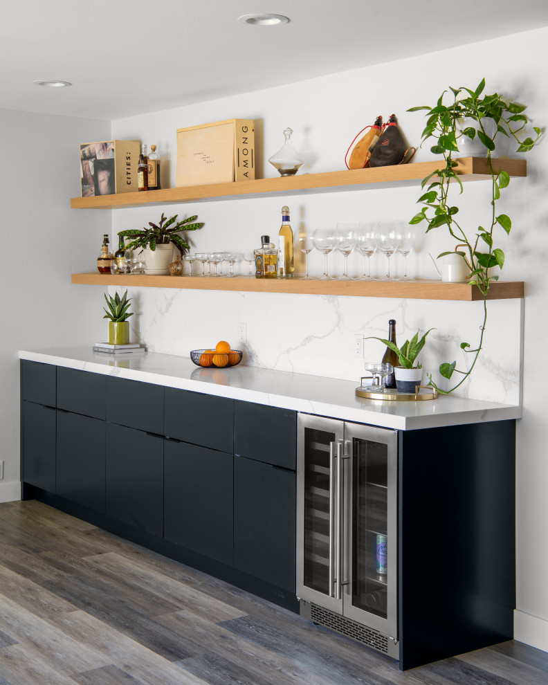 Inspiration for a contemporary single-wall home bar in Orange County with no sink, flat-panel cabinets, black cabinets, marble benchtops, multi-coloured splashback, marble splashback, medium hardwood floors, brown floor and multi-coloured benchtop.